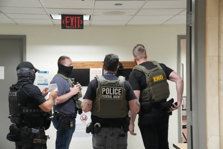 Ice agents wait to arrest people inside a courthouse in New York.