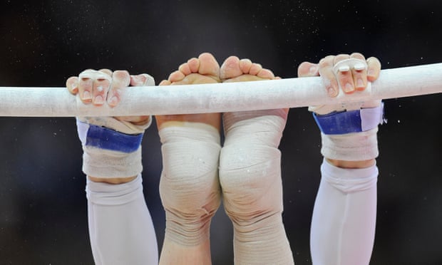 A gymnast’s hands and feet on the uneven bars during the Women’s artistic gymnastics qualification at London 2012