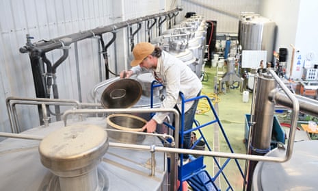 A worker checks a brewing vessel at Pressure Drop brewery in north London, which is taking part in a six-month trial of a four-day working week in the UK.