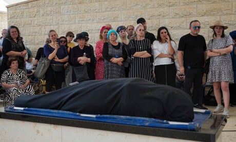 Mourners gather around the body of Hana Nachenberg during her funeral in Modiin, Israel