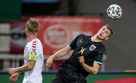 Austria’s forward Sasa Kalajdzic heads the ball.