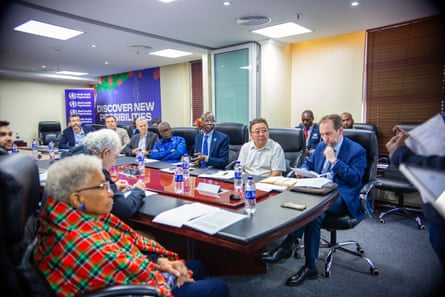 People sit around a boardroom table.