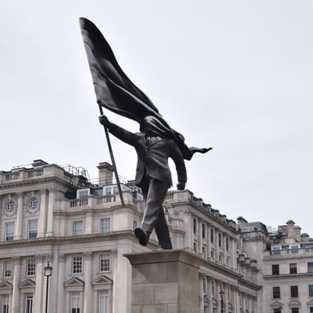 A statue depicting a man holding a flag which obscures his face, and signed ‘Banksy’ at the base of the plinth in central London.