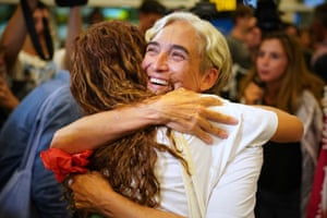 Ada Colau hugs a woman.
