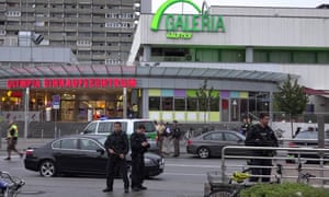 Police guard the Olympic Park shopping centre after the attack.