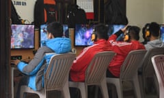People play online games at an internet cafe in Hanoi, Vietnam