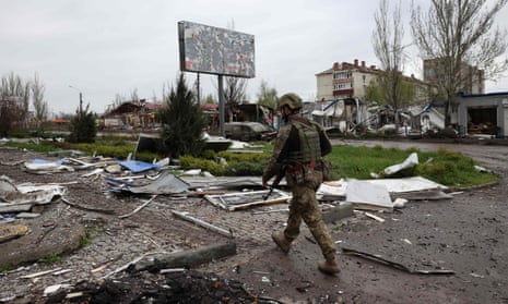 A Ukrainian soldier walks down a street in Bakhmut.