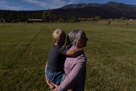 Carla Gomez walks her property with her grandson