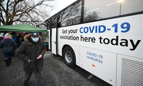 People receive their Covid vaccine shots on an NHS bus in Farnworth, north-west England