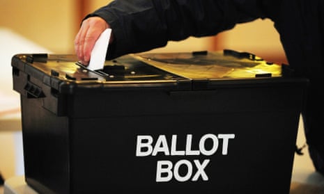 A voter placing a ballot paper in a ballot box