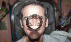 Canadian Space Agency astronaut Chris Hadfield, Expedition 34 flight engineer, watches a water bubble float freely between him and the camera, showing his image refracted, in the Unity node of the International Space Station, in this handout photo courtesy of NASA, taken January 21, 2013. Hadfield becomes the first Canadian commander of the International Space Station, March 13, 2013. REUTERS/NASA/Handout (OUTER SPACE - Tags: SCIENCE TECHNOLOGY) FOR EDITORIAL USE ONLY. NOT FOR SALE FOR MARKETING OR ADVERTISING CAMPAIGNS. THIS IMAGE HAS BEEN SUPPLIED BY A THIRD PARTY. IT IS DISTRIBUTED, EXACTLY AS RECEIVED BY REUTERS, AS A SERVICE TO CLIENTS