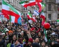 Throng of people waving mainly Iranian flags
