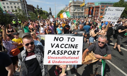 People hold anti-vaccine-passport placards at a protest in Dublin