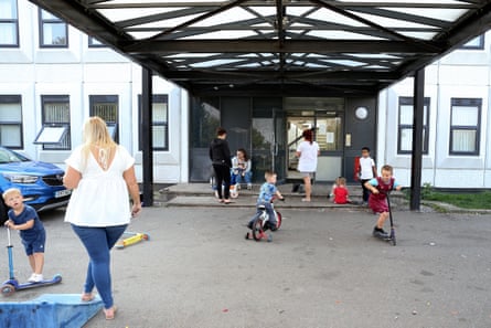 Children play in the car park at the entrance to Shield House.