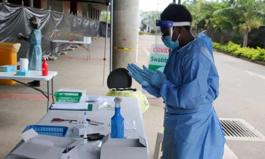A health worker prepares to do tests for Covid-19 coronavirus outside a makeshift clinic in a sports stadium in Port Moresby on April 1, 2021.