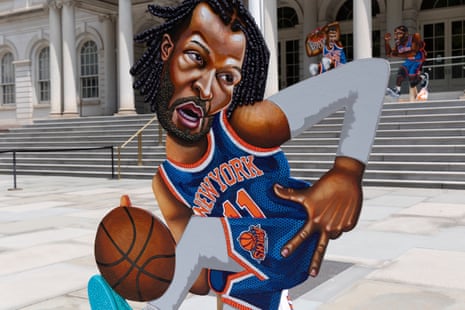 A cutout portrait of Jalen Brunson stands on the plaza outside City Hall in New York.