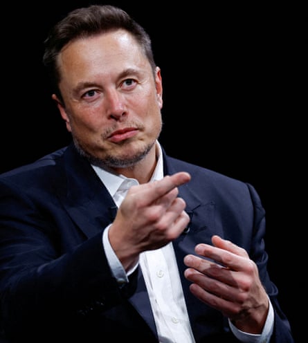 Elon Musk in a jacket and shirt gestures by pointing during the VivaTech conference in Paris