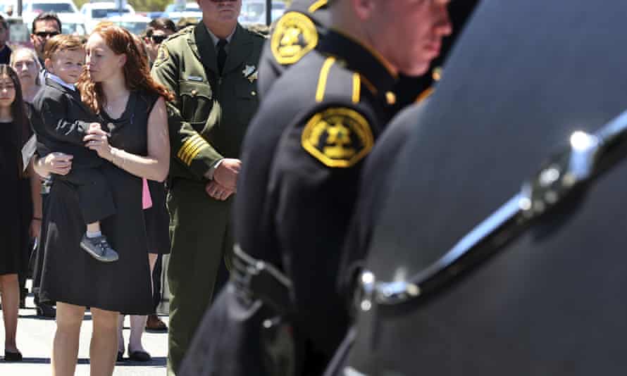 Faviola Del Real holds her son, Carter, as the coffin of her husband, Damon Gutzwiller, is loaded into a hearse following a memorial on 17 June 2020, in Santa Cruz.