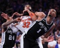 Karl-Anthony Towns and Victor Wembanyama get tangled up on a play during the fourth quarter of Monday night’s game.