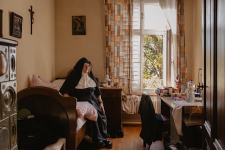 Sister Rita sitting on her bed in her room.