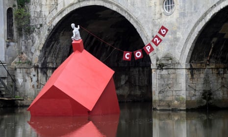 An installation of a ‘Sinking House’ is partly submerged to highlight climate change ahead of COP26, in Bath, Britain.