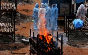 Giddenahalli, India Relatives perform the last rites for COVID-19 victims during their funeral at a mass cremation ground on the outskirts of Bangalore
