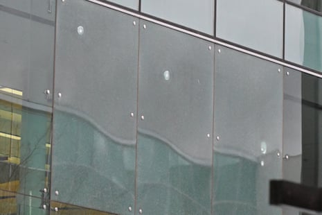 Three gunshots are seen on the airport glass in Canberra on Sunday afternoon.
