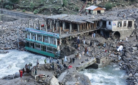 Residents and rescue workers inspect buildings damaged by heavy flooding in the eastern province of Nuristan, Afghanistan.