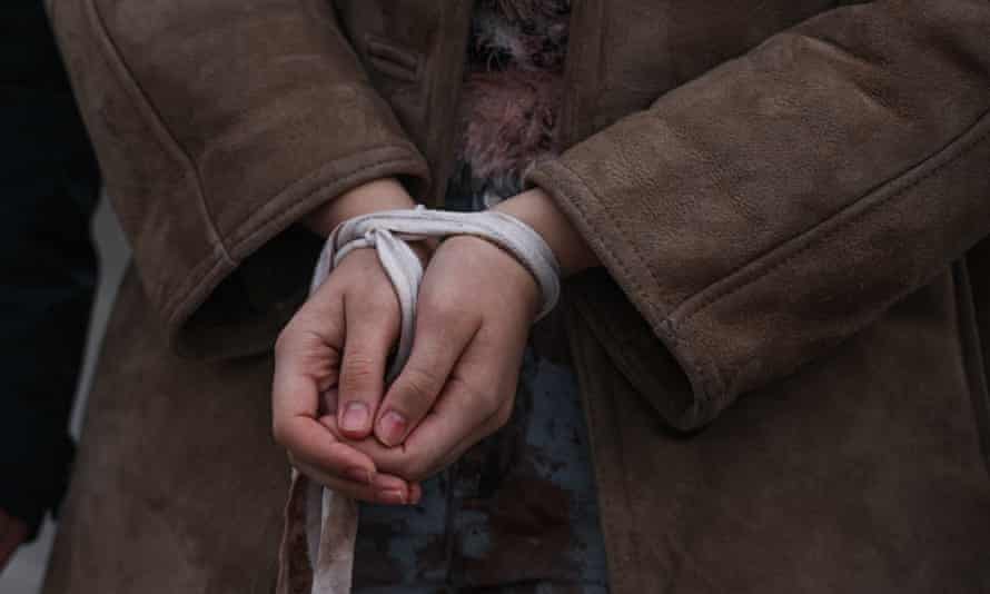 A Ukrainian woman with tied up hands takes part in a silent protest against the mass killing of Ukrainian civilians by the Russian army in Krakow, Poland.