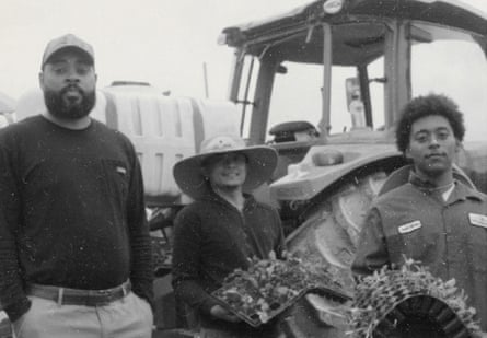 Three people in front of tractor