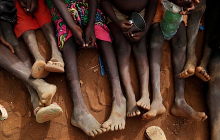 The legs and feet of six African children