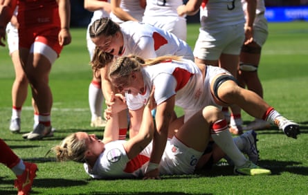 Marlie Packer (bottom, lying on the ground) celebrates wth teammates after scoring England’s third try.