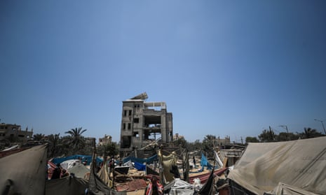 Palestinians inspect the scene after an Israeli air strike in the Al-Mawasi area of Khan Yunis, southern Gaza Strip.