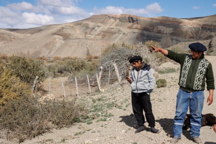 Sergio Pichiñán points across the river toward the old uranium mines in Patagonia.