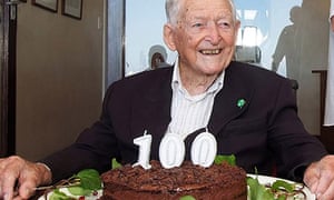 Mike Hoare pictured in March 2019 with birthday cake and '100' candles
