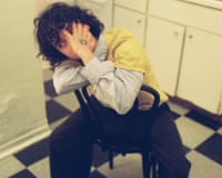 Superfan, AKA Kali Flanagan, sat in a kitchen with his hand over his face