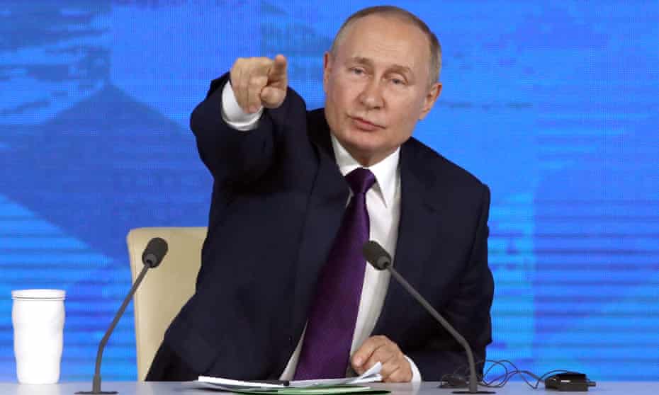 Vladimir Putin gestures during his annual end-of-year news conference in Moscow