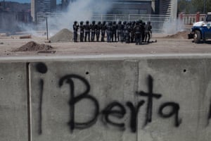 Riot police in front of the National University of Honduras use teargas on students protesting