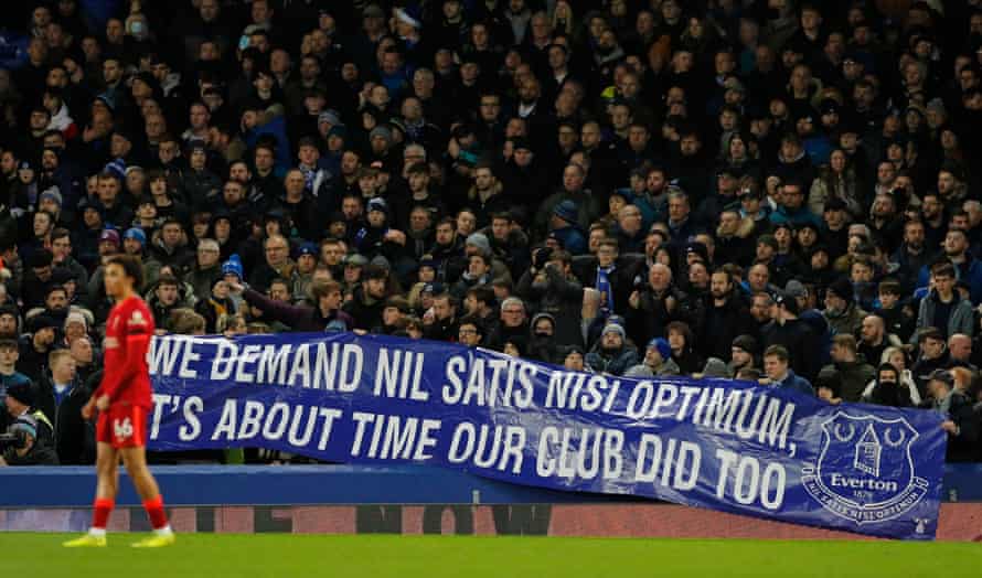 Fed up Everton fans make their feelings known by unfurling a banner with their club motto.