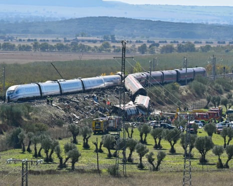 Derailed high-speed trains lie crumpled on tracks as emergency crews respond near Toledo, Spain