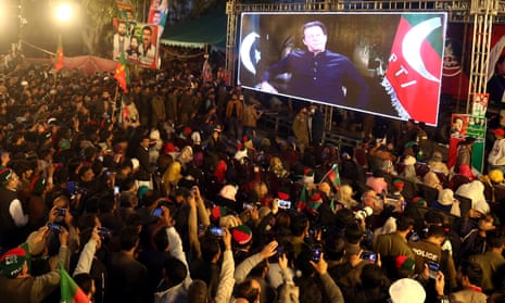 Supporters in Rawa, Pakistan, watch a televised address by Imran Khan.