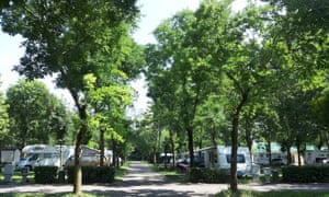 Camping Milano with caravans under trees