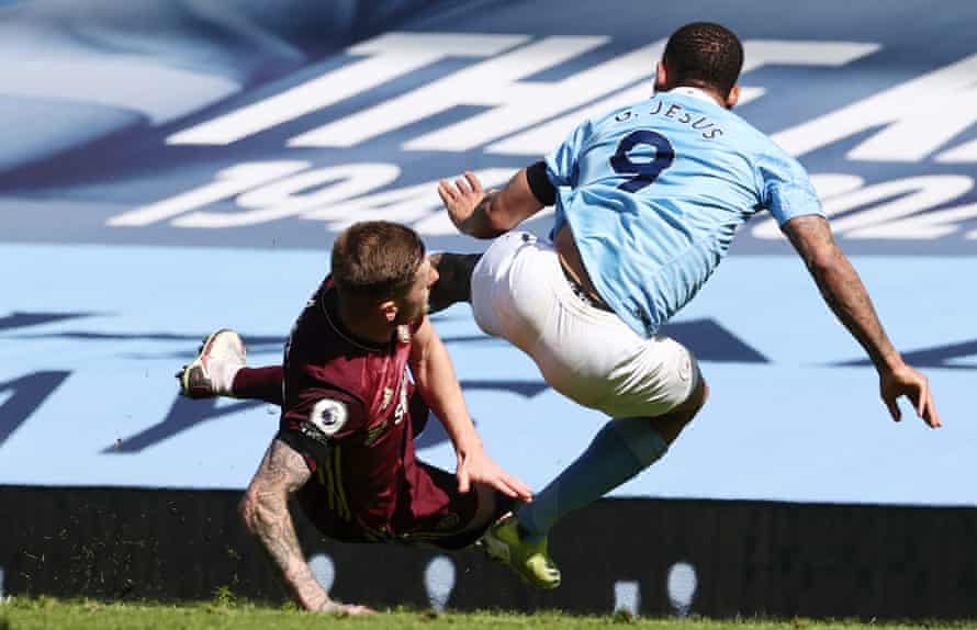 Liam Cooper fouls Gabriel Jesus after clearing the ball, a challenge that resulted in a red card for the Leeds player.