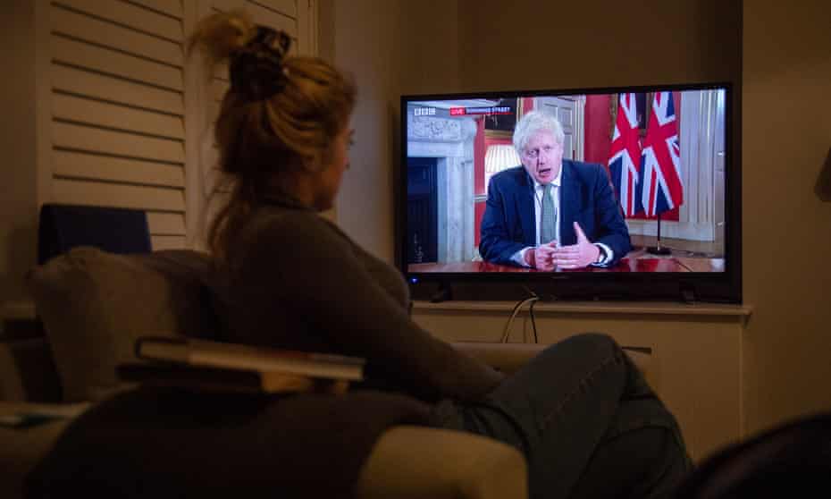 Woman watches Boris Johnson on TV