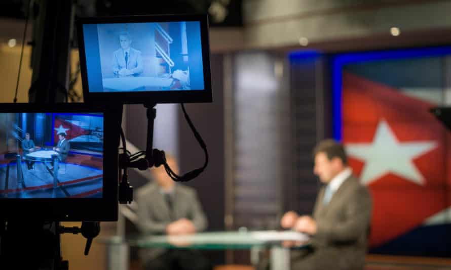Reporter Amado Gil, right, tapes a segment with guest Alexis Jardines at the TV Martí studio in Miami on 9 March 2015.