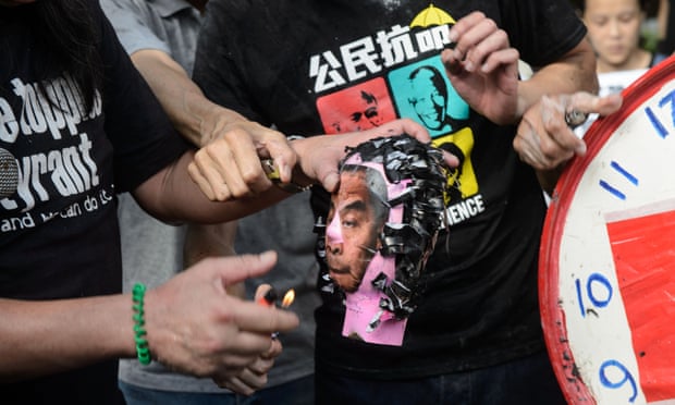Activists set fire to a paper model of Hong Kong chief executive CY Leung.