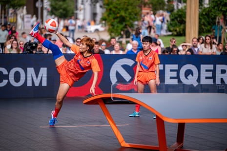 Suphawadi Wongkhamchan kicks the ball high overhead beside a teqball table during a match