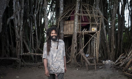 Singer-songwriter Tio Massing lives, Buddha-like, amid the roots of a sprawling banyan tree.