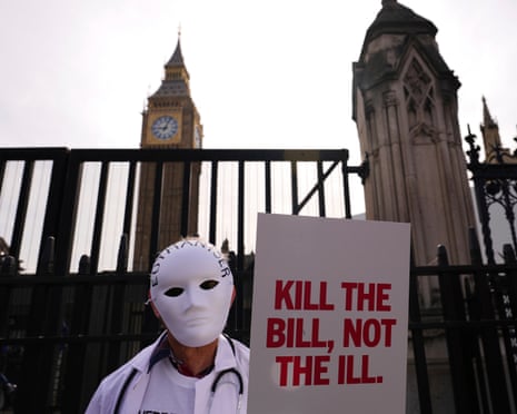 A demonstrator against assisted dying holds a placard outside parliament on Friday.