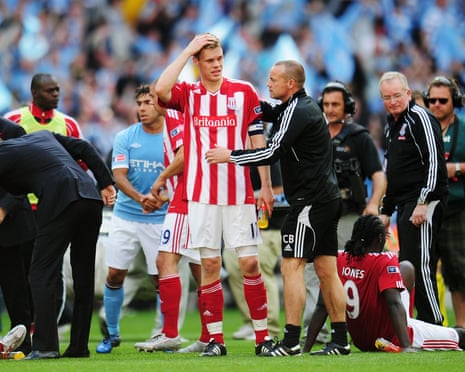 Ryan Shawcross (centre) of Stoke City is consoled by teammates after his side’s defeat in the 2011 FA Cup final